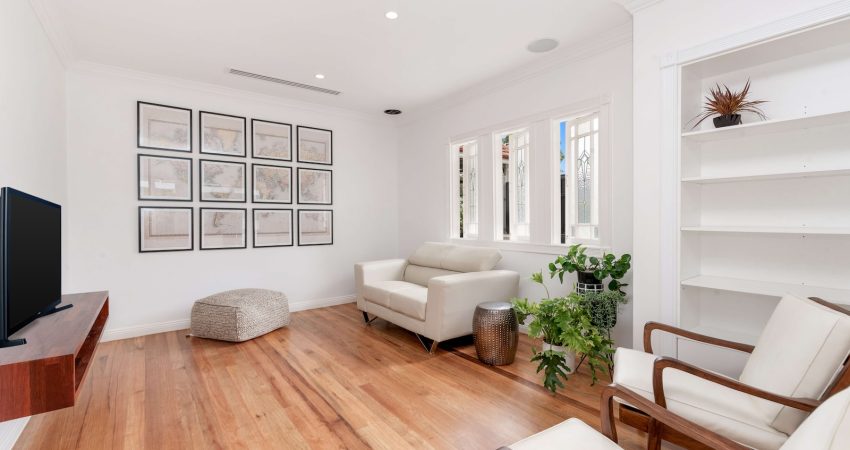 a living room filled with furniture and a flat screen tv